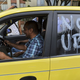 Someone demonstrating the kind of transparency that Uber presumably has never heard of. (Photo: Luis Robayo/AFP/Getty)